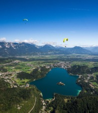 Two Tandem Paragliders Above Lake Bled