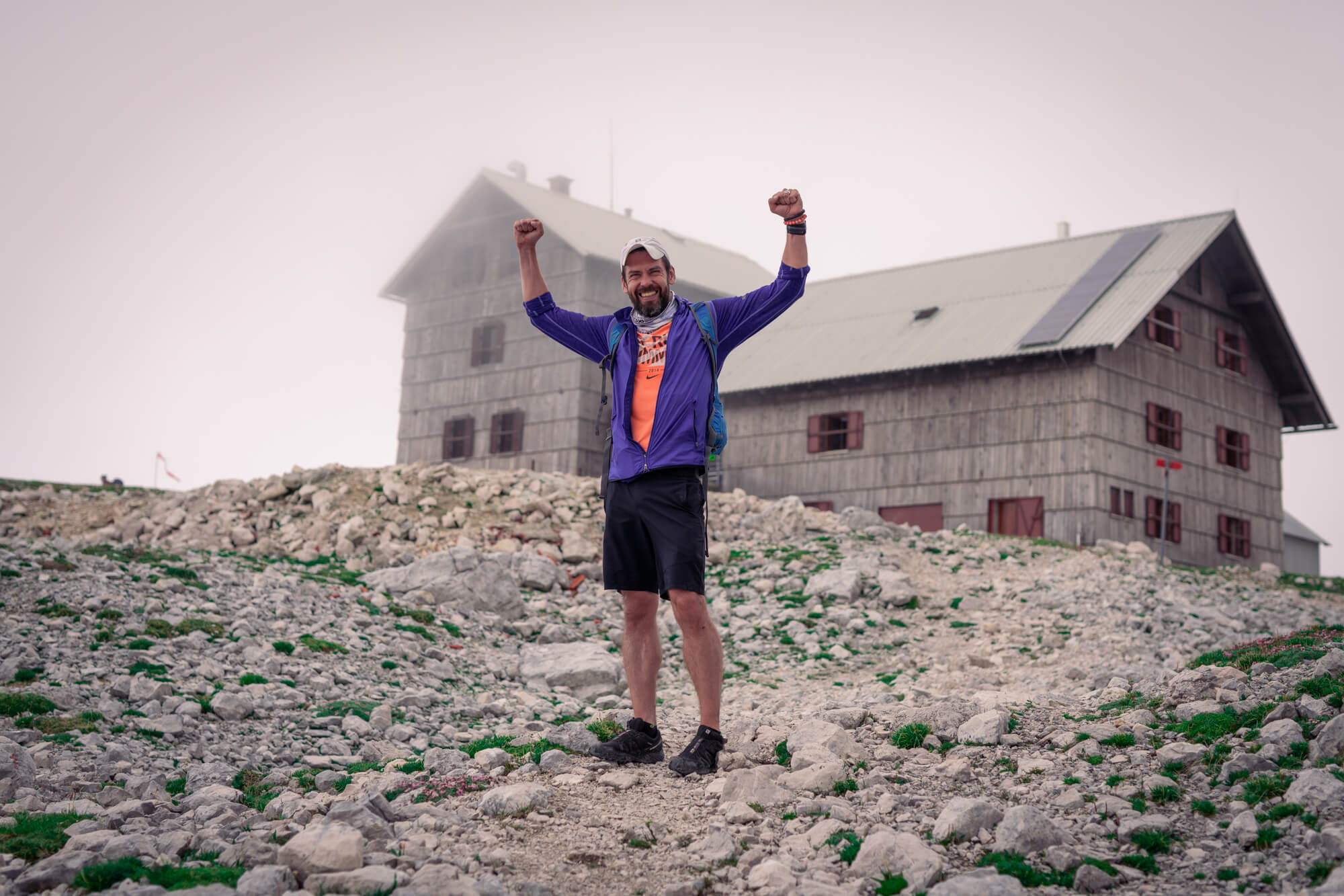 Trail Runner with Wide Open Hands at Planika Hut, Triglav National Park