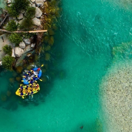 Aerial image of a pontoons on a crystal blue waters of river Soca