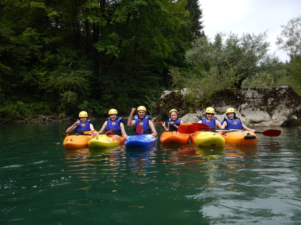 Kayaking Kayaking Slovenia: Kayakers floating side by side in calm green water, ready for a group paddling activity.
