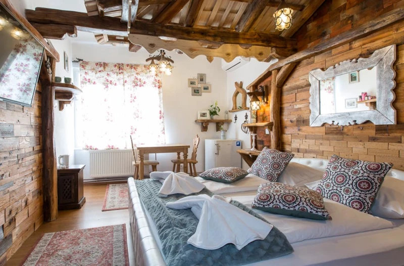 Cozy rustic bedroom with wooden beams and traditional decor at Central Bled House
