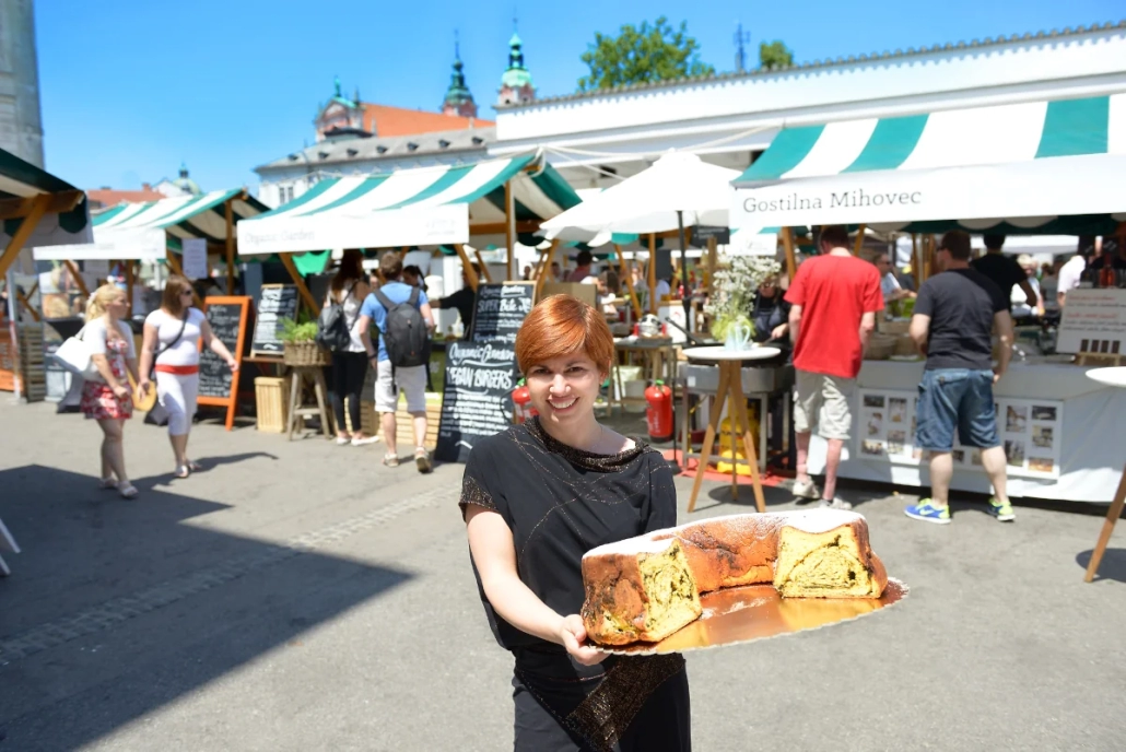 Local food vendor serving traditional dishes at Ljubljana central market