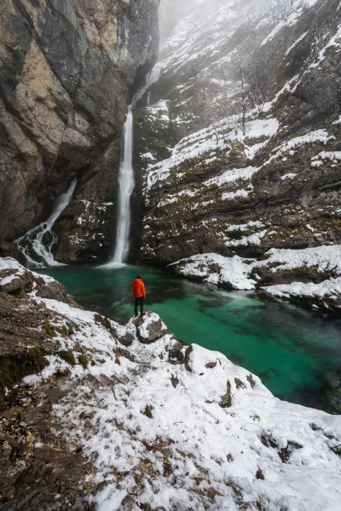 Winter canyon with turquoise river and snow-covered rocks in Slovenia